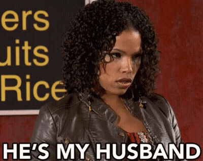 Woman Says He's My Husband In Front Of Sign GIF