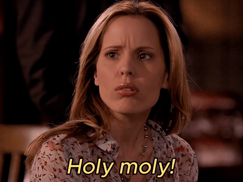 Woman Says Holy Moly With Floral Shirt GIF