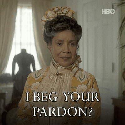 Woman Says I Beg Your Pardon In Yellow And White Dress GIF