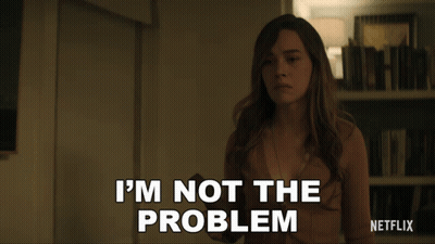 Woman Says I'm Not The Problem In Front Of Bookshelf GIF