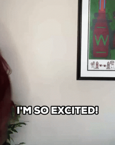 Woman Says I'm So Excited In Front Of Framed Picture GIF