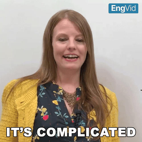 Woman Says It's Complicated In Yellow Cardigan GIF