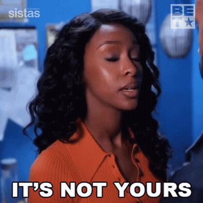 Woman Says It's Not Yours In Front Of Blue Wall GIF