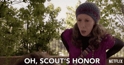 Woman Says Oh Scouts Honor In Front Of Fence GIF