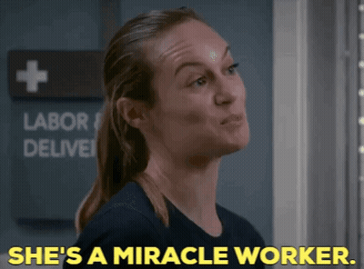 Woman Says She's A Miracle Worker In Front Of Labor Deliver Sign GIF