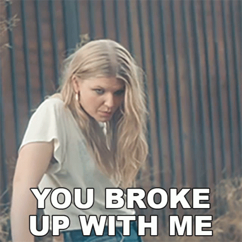 Woman Says You Broke Up With Me In Front Of Wooden Fence GIF