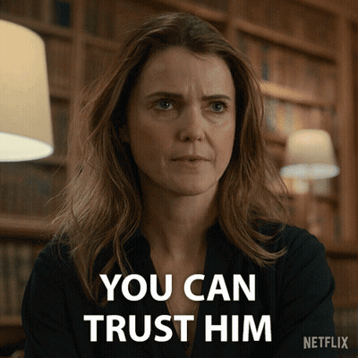 Woman Says You Can Trust Him In Front Of Bookshelf GIF