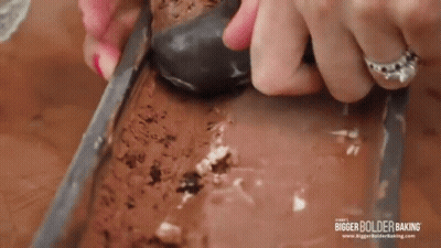 Woman Scooping Ice Cream From Loaf Pan GIF