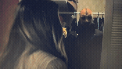 Woman Screaming Behind Man Sitting On Bed GIF
