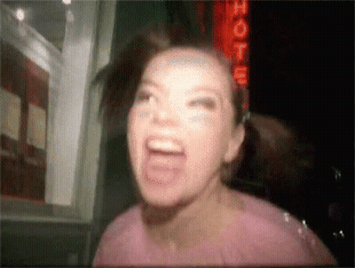 Woman Screaming In Front Of Hotel Sign GIF