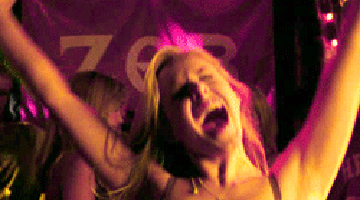 Woman Screaming With Arms In Air In Front Of ZGR Sign GIF