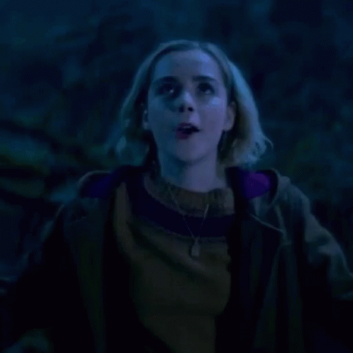 Woman Screaming With Mouth Open In Dark GIF