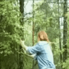 Woman Shaking Green Tree Bark