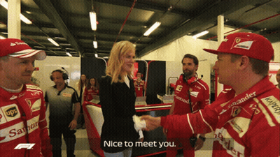 Woman Shaking Hands With Man In Red Santander Hat GIF
