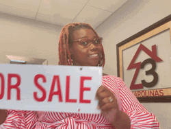 Woman Showing For Sale Sign GIF