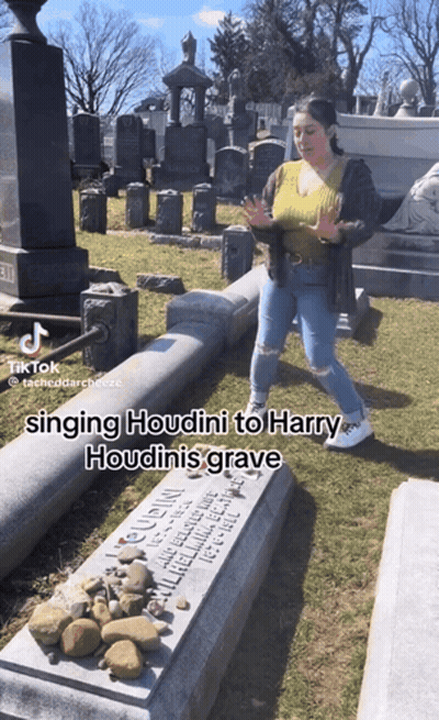 Woman Singing Houdini At Harry Houdini's Grave GIF
