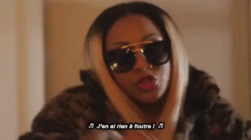 Woman Singing In French With Sunglasses And Fur Coat GIF