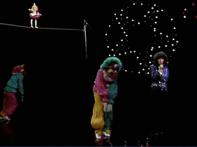 Woman Singing In Front Of Clowns On A Rope GIF