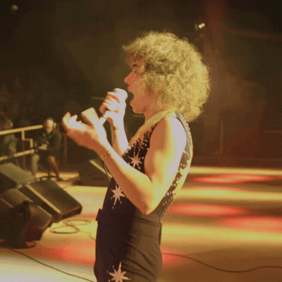 Woman Singing In Star Jumpsuit GIF