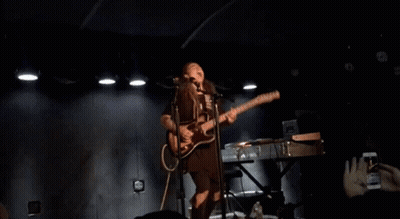 Woman Singing Into Microphone And Playing Guitar GIF