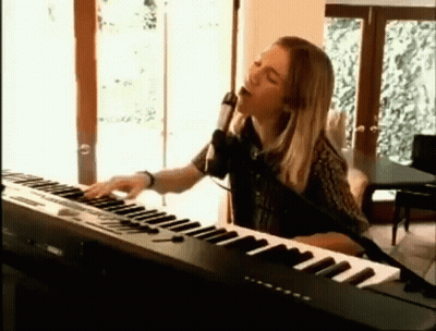 Woman Singing Into Microphone And Playing Keyboard GIF