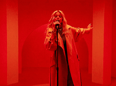 Woman Singing Into Microphone Arms Outstretched GIF