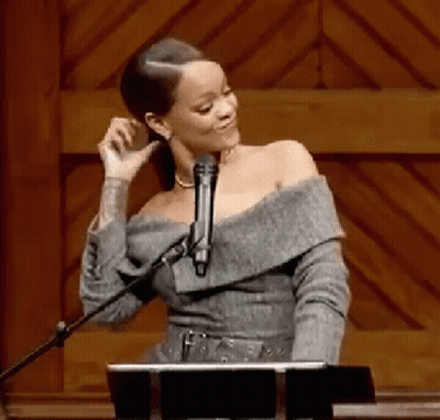 Woman Singing Into Microphone At Wooden Podium GIF