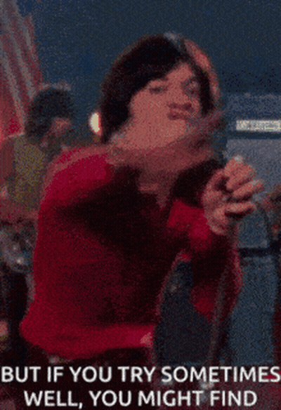 Woman Singing Into Microphone But If You Try Sometimes Well You Might Find GIF