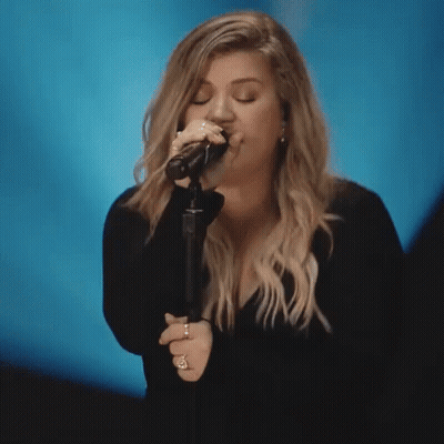 Woman Singing Into Microphone Eyes Closed GIF