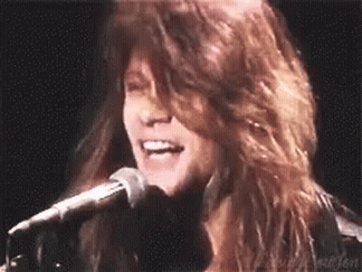Woman Singing Into Microphone