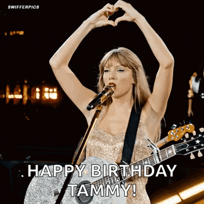 Woman Singing Into Microphone Holding Guitar Making Heart With Hands GIF