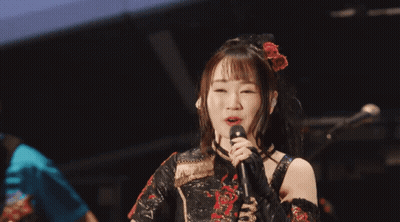 Woman Singing Into Microphone In Black Dress GIF