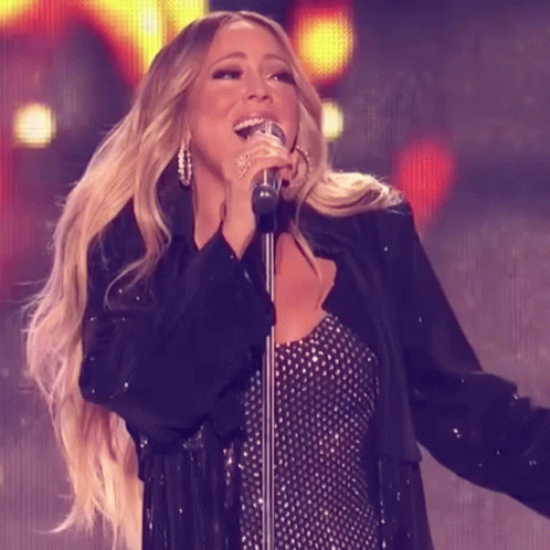 Woman Singing Into Microphone In Black Jacket GIF