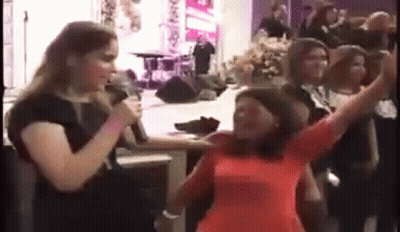 Woman Singing Into Microphone In Church, People Dancing GIF