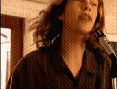 Woman Singing Into Microphone In Dark Room GIF