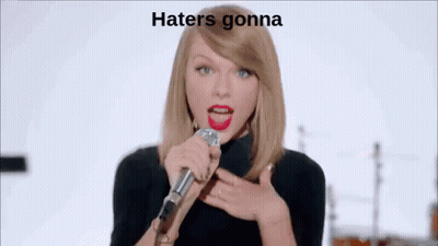 Woman Singing Into Microphone In Front Of Band Saying Hate GIF