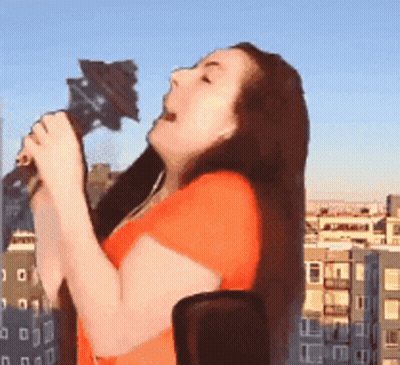 Woman Singing Into Microphone In Front Of City GIF