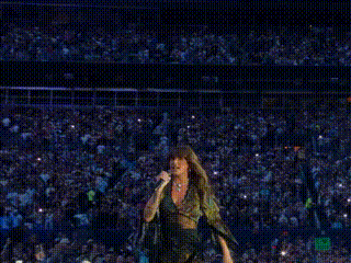 Woman Singing Into Microphone In Front Of Crowd GIF