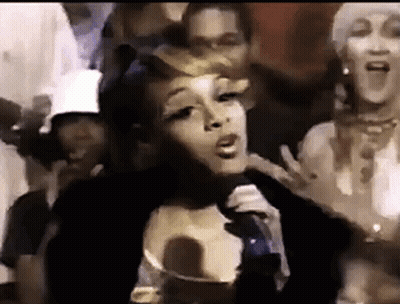 Woman Singing Into Microphone In Front Of Crowd GIF