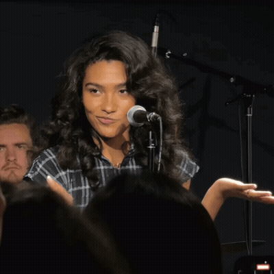 Woman Singing Into Microphone In Front Of Crowd GIF