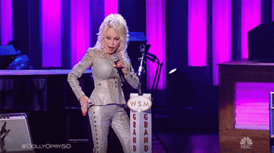 Woman Singing Into Microphone In Front Of WSM Sign GIF