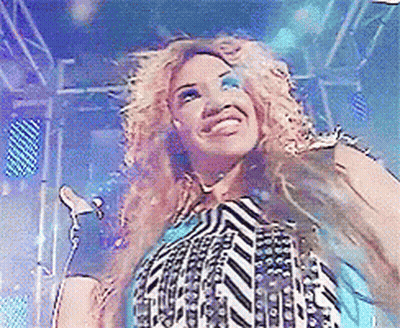 Woman Singing Into Microphone In Striped Shirt GIF