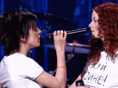 Woman Singing Into Microphone Next To Woman In Oihae T-Shirt GIF