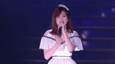 Woman Singing Into Microphone On Stage GIF