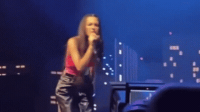 Woman Singing Into Microphone On Stage GIF