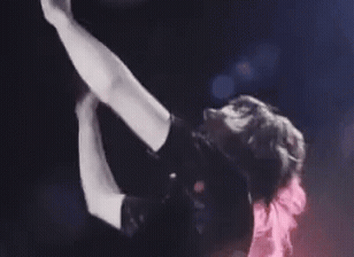 Woman Singing Into Microphone On Stage Arms Outstretched GIF