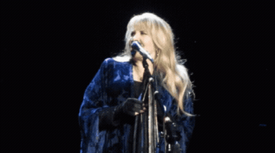 Woman Singing Into Microphone On Stage GIF