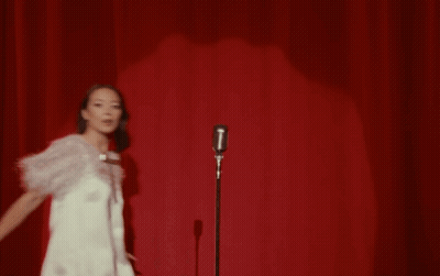 Woman Singing Into Microphone On Stage GIF