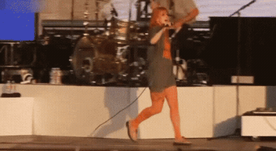 Woman Singing Into Microphone On Stage GIF