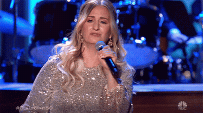 Woman Singing Into Microphone On Stage With NBC Logo GIF